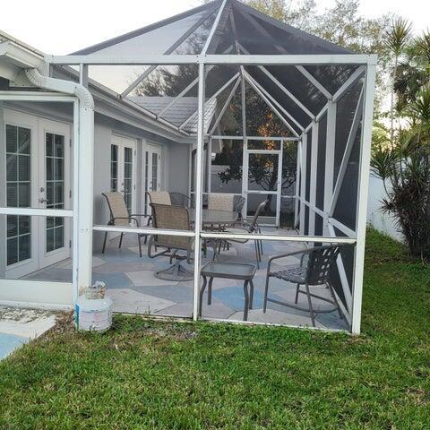 2285 Saratoga Ln, West Palm Beach, FL 33409 - view of patio / terrace featuring a lanai and french doors