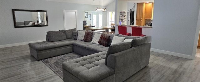 2285 Saratoga Ln, West Palm Beach, FL 33409 - living area featuring light wood-style floors, baseboards, and vaulted ceiling