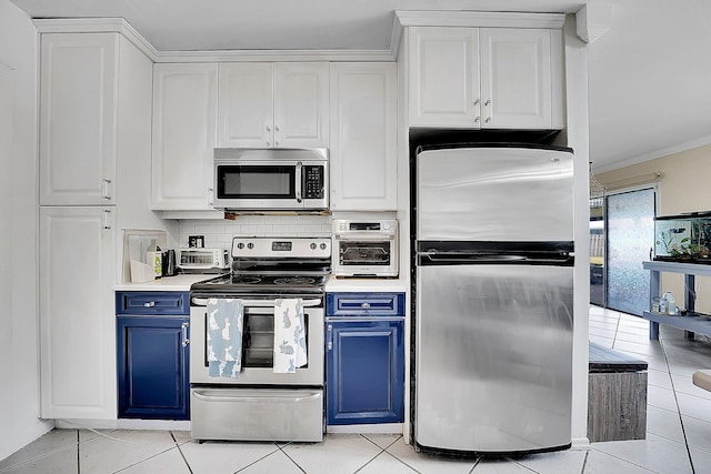 kitchen featuring white cabinets, stainless steel appliances, and blue cabinets