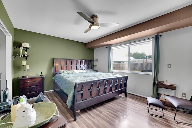 bedroom with baseboards, wood finished floors, and a ceiling fan