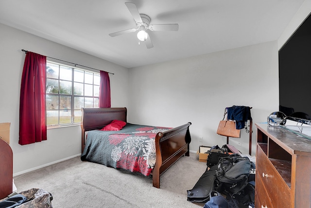 bedroom featuring baseboards, ceiling fan, and carpet