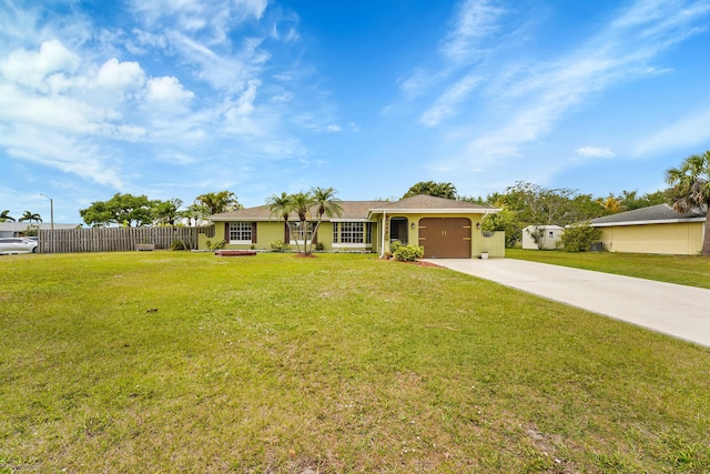ranch-style house with driveway, a front yard, fence, and a garage