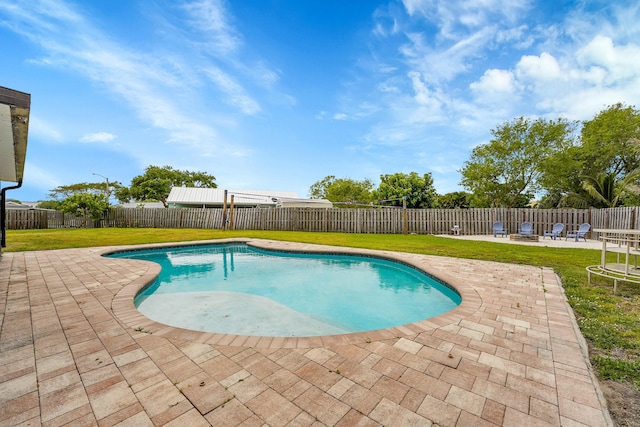 view of pool featuring a lawn, a fenced in pool, a fenced backyard, and a patio area