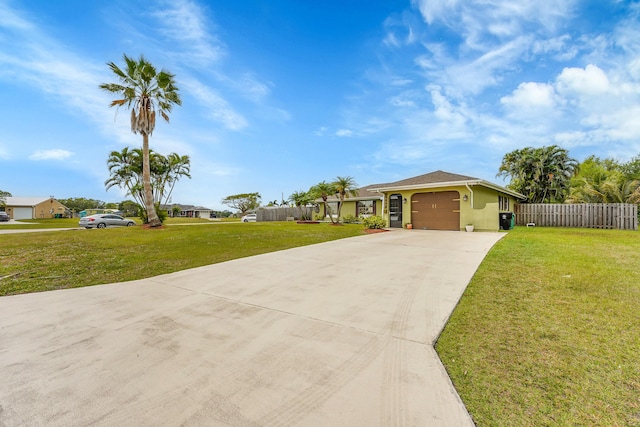 ranch-style house with driveway, stucco siding, fence, and a front lawn