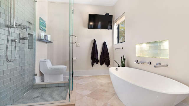 1526 SE 11th St, Deerfield Beach, FL 33441 - bathroom featuring a shower stall, toilet, a freestanding bath, baseboards, and tile patterned flooring