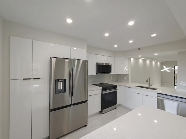 7240 Huntington Ln Unit 408, Delray Beach, FL 33446 - kitchen featuring stainless steel appliances, modern cabinets, a sink, light marble finish floors, and recessed lighting