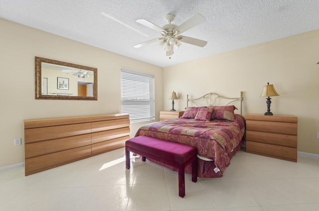 14112 Huntington Pointe Dr Unit 105, Delray Beach, FL 33484 - bedroom featuring tile patterned flooring, baseboards, a textured ceiling, and a ceiling fan