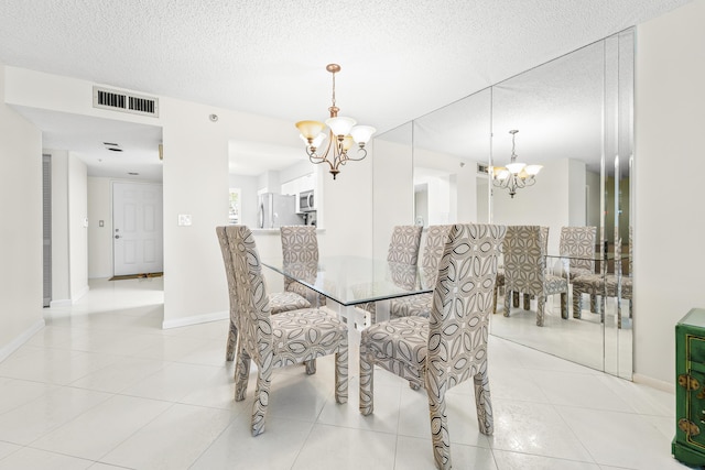 14112 Huntington Pointe Dr Unit 105, Delray Beach, FL 33484 - dining space featuring an inviting chandelier, light tile patterned floors, visible vents, and a textured ceiling