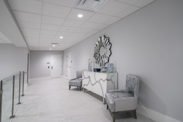 14112 Huntington Pointe Dr Unit 105, Delray Beach, FL 33484 - living area featuring visible vents, a paneled ceiling, marble finish floor, and baseboards