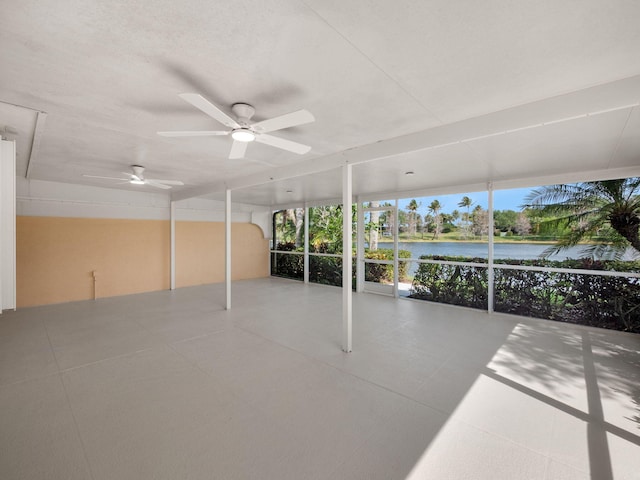 unfurnished sunroom with a healthy amount of sunlight and a water view