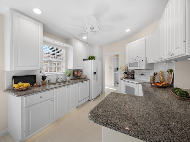 kitchen featuring ceiling fan, a sink, white appliances, tasteful backsplash, and white cabinetry