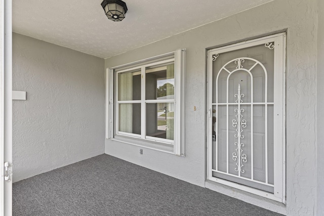 doorway to property with stucco siding