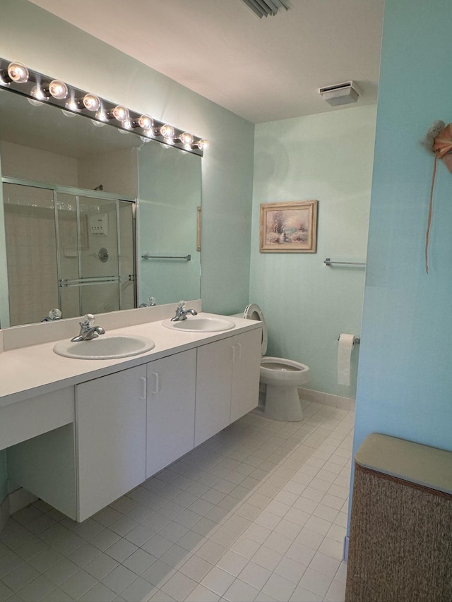 bathroom featuring a sink, double vanity, a stall shower, and tile patterned floors