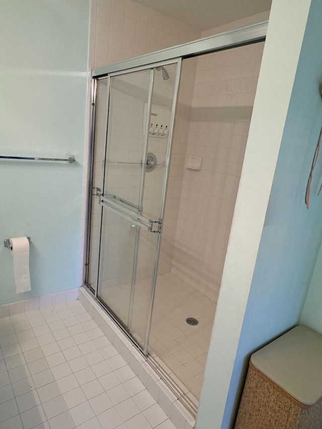 bathroom with tile patterned floors and a stall shower