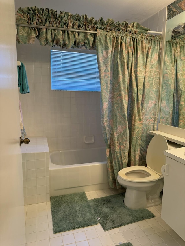 bathroom featuring tile patterned floors, vanity, toilet, and shower / tub combo