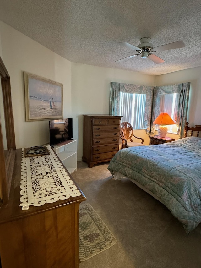 bedroom with light colored carpet, a textured ceiling, and a ceiling fan