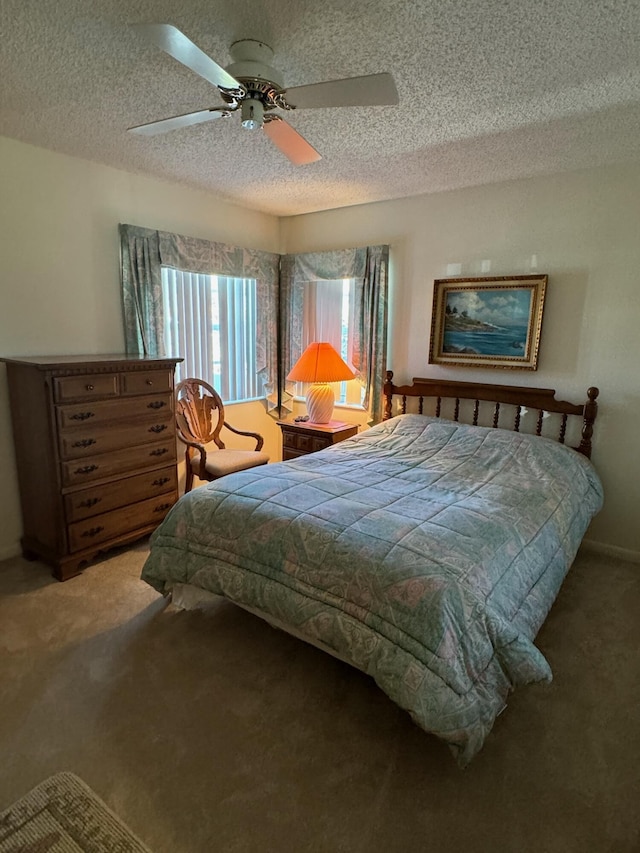 carpeted bedroom featuring a textured ceiling and ceiling fan