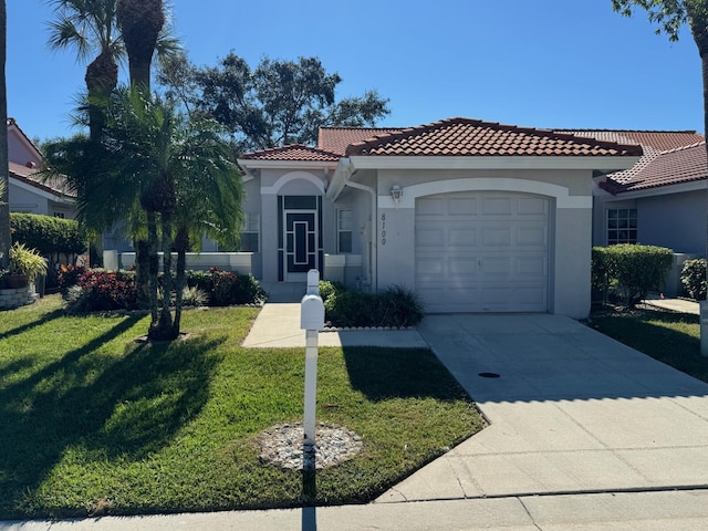 mediterranean / spanish home featuring a front yard, stucco siding, concrete driveway, a garage, and a tiled roof