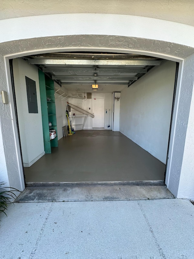 garage featuring electric panel and a garage door opener