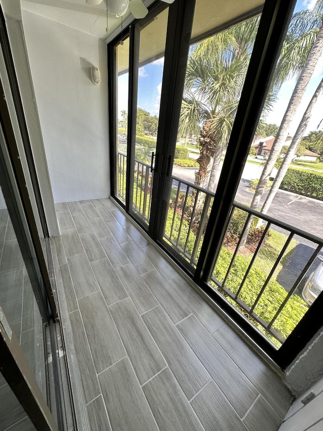 unfurnished sunroom featuring wood finish floors