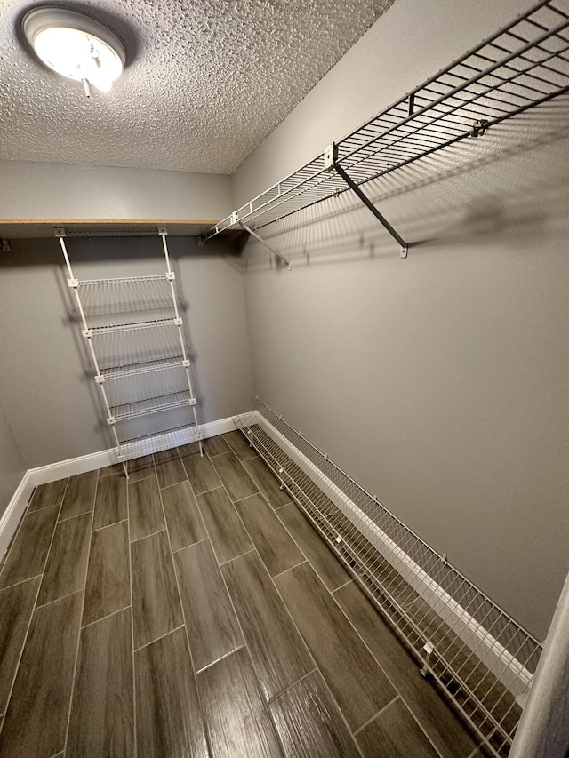 walk in closet featuring wood tiled floor