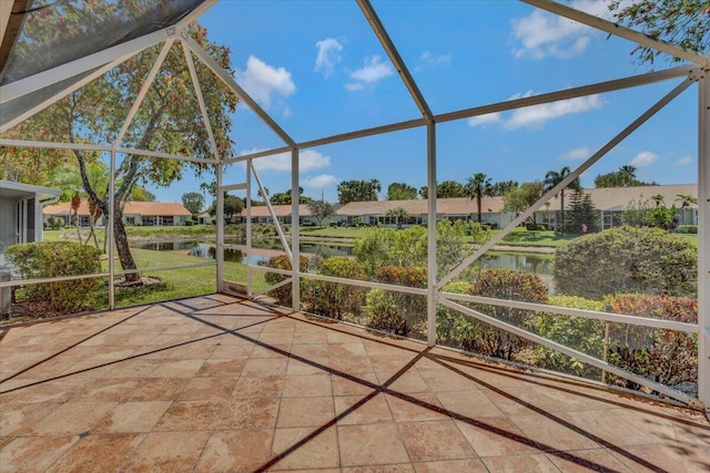 unfurnished sunroom featuring a water view