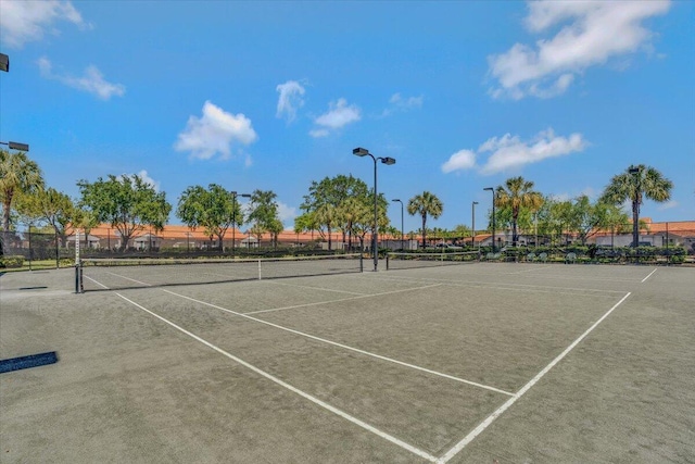 view of tennis court featuring fence
