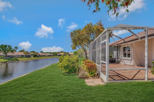 view of yard featuring a residential view, a lanai, a water view, and a patio