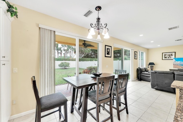 dining area featuring visible vents, light tile patterned floors, and a healthy amount of sunlight