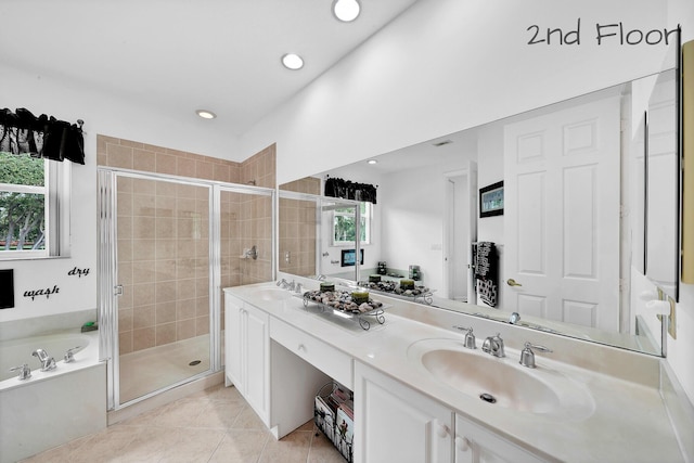 full bathroom featuring a sink, a bath, a stall shower, double vanity, and tile patterned flooring