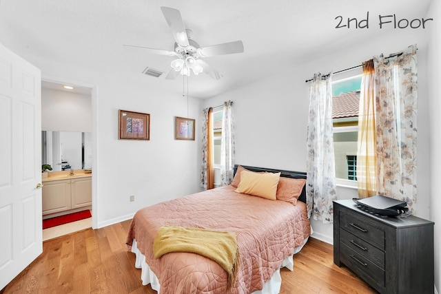 bedroom featuring recessed lighting, light wood-type flooring, ensuite bathroom, baseboards, and visible vents