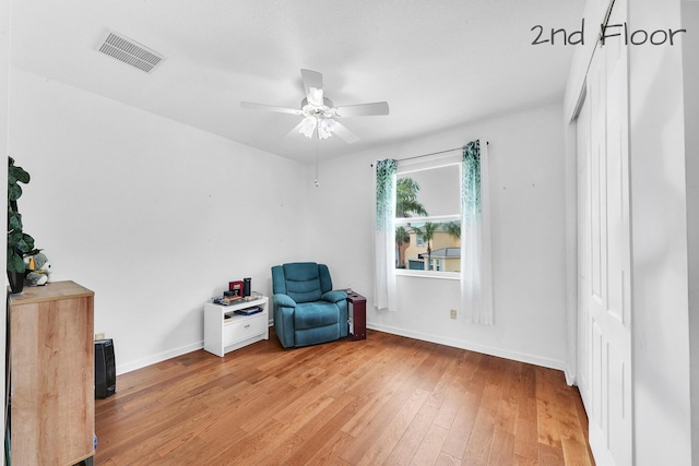 unfurnished room with visible vents, a ceiling fan, light wood-style flooring, and baseboards