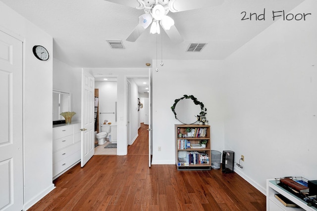 misc room featuring baseboards, visible vents, wood finished floors, and a ceiling fan