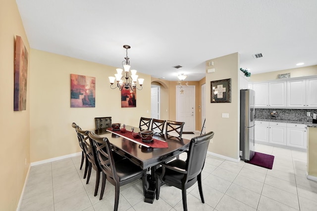 dining room with light tile patterned floors, baseboards, an inviting chandelier, arched walkways, and recessed lighting