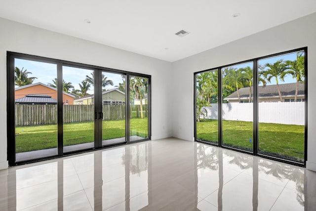 empty room featuring visible vents and light tile patterned flooring