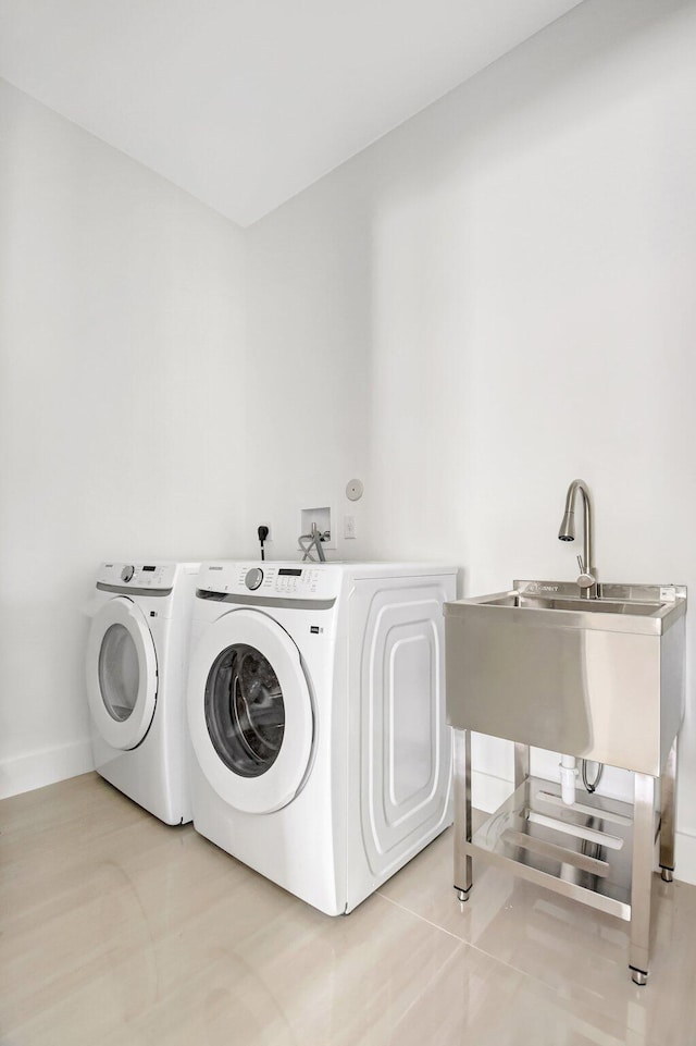 laundry room featuring baseboards, independent washer and dryer, and laundry area
