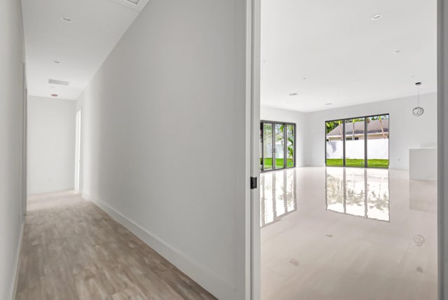corridor with light wood finished floors