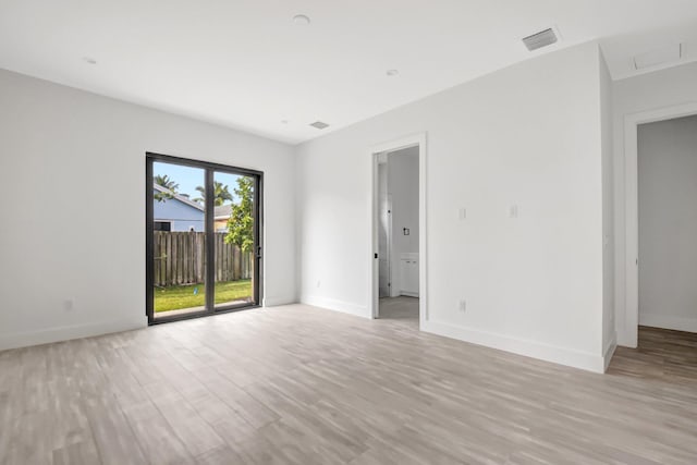 unfurnished room featuring light wood-type flooring and baseboards