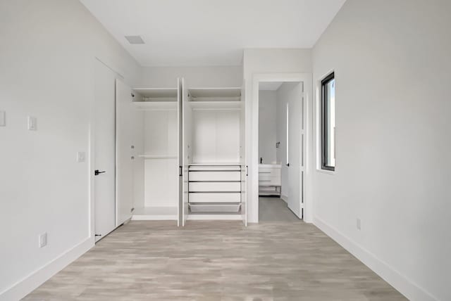 unfurnished bedroom with baseboards and light wood finished floors