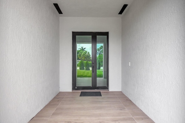 property entrance featuring french doors and stucco siding