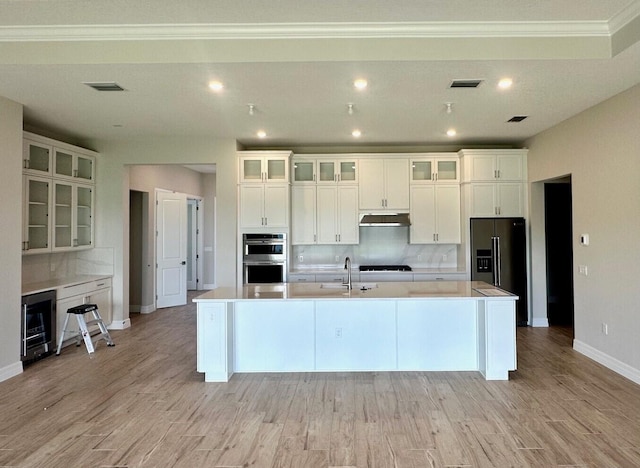 10734 Stellar Cir Unit Stardom 9, Palm Beach Gardens, FL 33412 - kitchen with fridge with ice dispenser, a sink, under cabinet range hood, stainless steel double oven, and beverage cooler