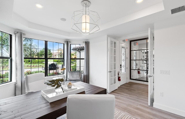 10734 Stellar Cir Unit Stardom 9, Palm Beach Gardens, FL 33412 - dining room with a tray ceiling, recessed lighting, french doors, baseboards, and light wood finished floors