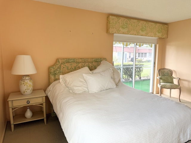 bedroom with carpet flooring, baseboards, and access to exterior