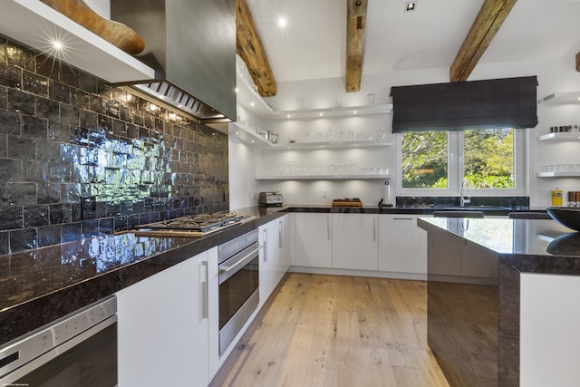 kitchen with white cabinets, open shelves, beamed ceiling, decorative backsplash, and appliances with stainless steel finishes