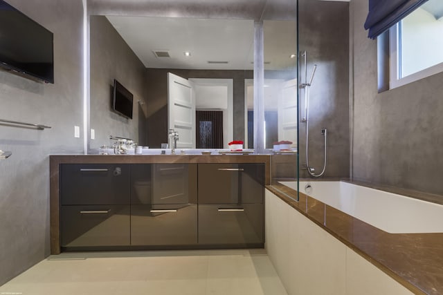 bathroom with visible vents, vanity, and  shower combination