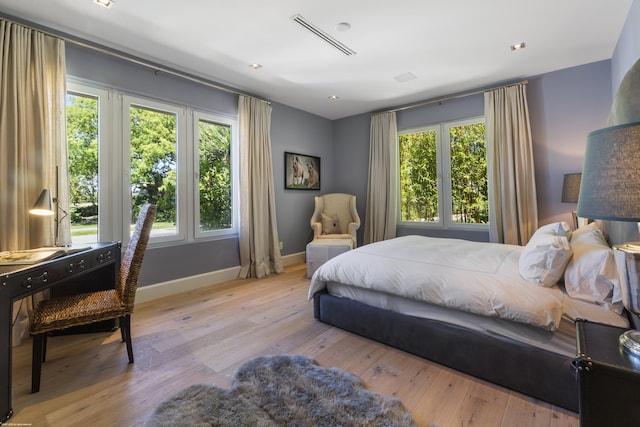 bedroom with hardwood / wood-style flooring and baseboards