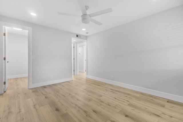 unfurnished bedroom with ceiling fan, visible vents, baseboards, a spacious closet, and light wood-style floors
