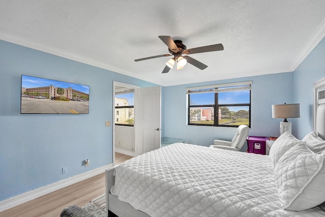 bedroom with baseboards, ornamental molding, a ceiling fan, and light wood-type flooring