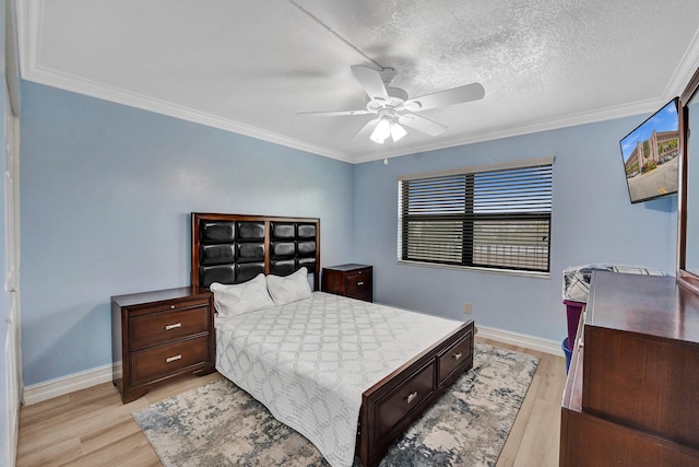bedroom with crown molding, baseboards, and light wood-style floors