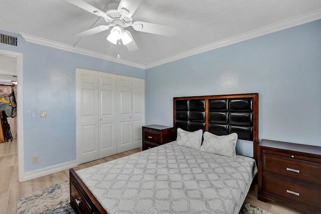 bedroom with visible vents, ornamental molding, a closet, and light wood-type flooring